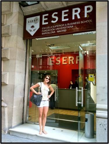 Student posing in front of business school in Spain