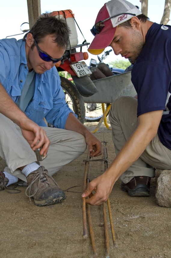 Two men working on a structure